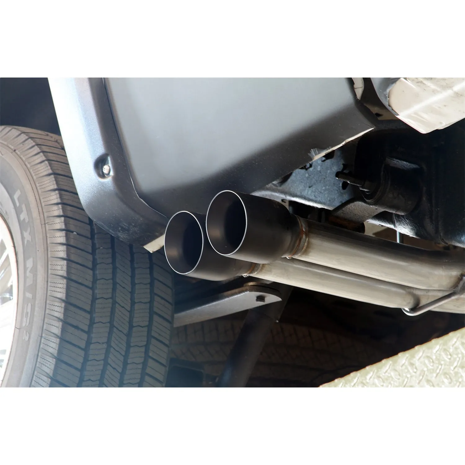 Flowmaster FlowFX Exhaust System - Cat-Back - 2-1/2" Diameter - Side Exit - Dual 4" Black Tips - Stainless